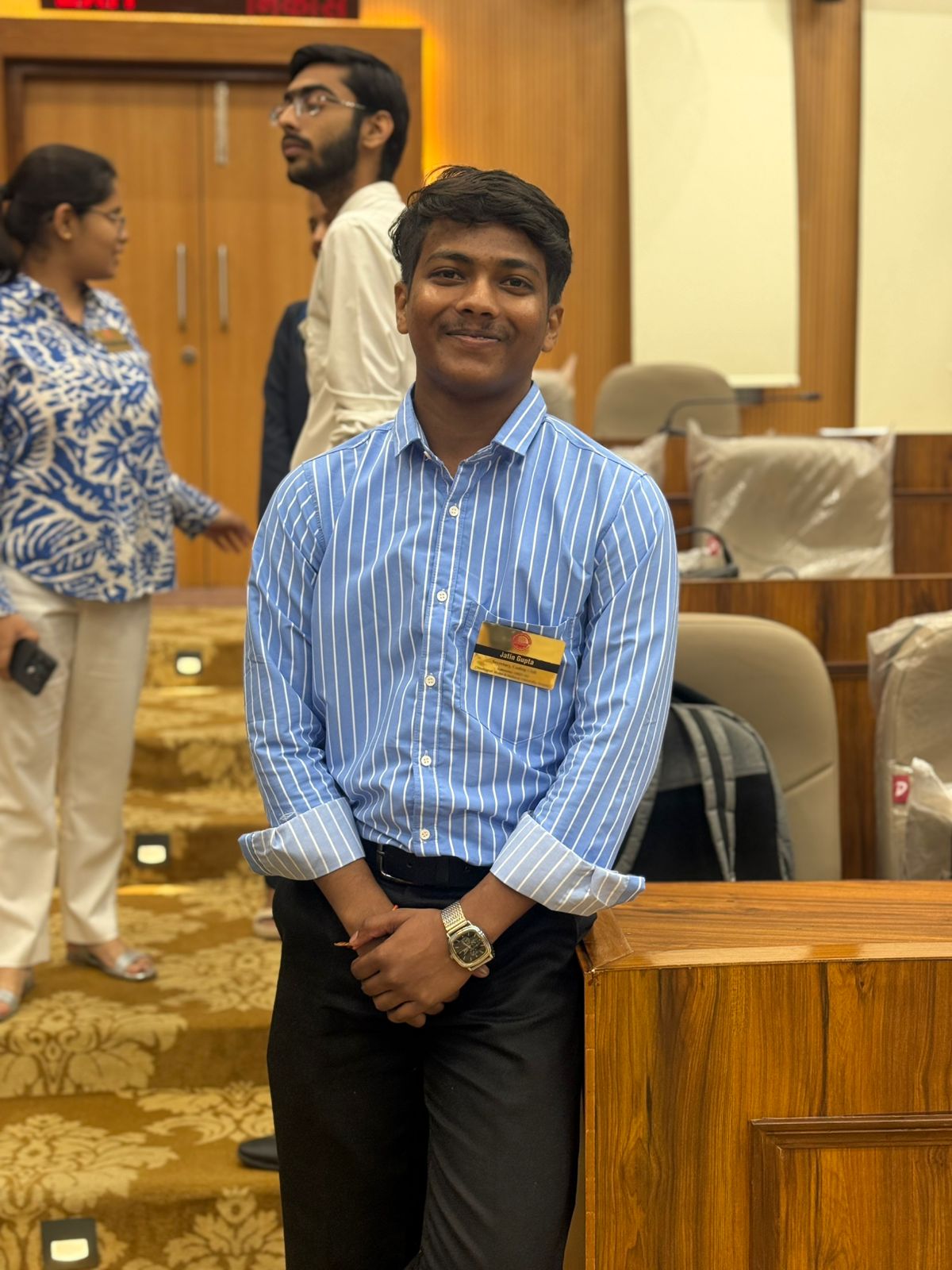 A man in a blue shirt with a happy expression